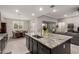 Island kitchen with granite countertops, stainless faucet, and an open concept design at 18368 W Long Lake Rd, Goodyear, AZ 85338