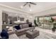 Open-concept living room with stylish sofas, decor, and access to the patio at 18368 W Long Lake Rd, Goodyear, AZ 85338