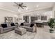 Open-concept living room with modern decor and seamless flow to the kitchen at 18368 W Long Lake Rd, Goodyear, AZ 85338