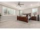 A spacious primary bedroom features a ceiling fan and carpeted floors and plantation shutters at 18368 W Long Lake Rd, Goodyear, AZ 85338
