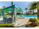 Inviting poolside cabana with seating and a view of the community pool and palm trees at 18368 W Long Lake Rd, Goodyear, AZ 85338