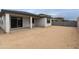 Unlandscaped backyard features a covered patio and block wall at 19039 W Rose Ln, Waddell, AZ 85355