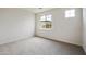 Neutral bedroom with carpeted flooring and two windows providing natural light at 19039 W Rose Ln, Waddell, AZ 85355