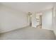 Spacious bedroom with plush carpeting and an open doorway to the en-suite bathroom at 19039 W Rose Ln, Waddell, AZ 85355