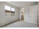 Well-lit bedroom with large window, carpet, and walk-in closet at 19039 W Rose Ln, Waddell, AZ 85355