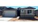 Single-story home featuring a gray exterior, attached two-car garage and low maintenance desert landscaping at 19039 W Rose Ln, Waddell, AZ 85355