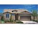 Charming single-story home with stone accents, desert landscaping and a large attached two-car garage at 19039 W Rose Ln, Waddell, AZ 85355