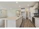 Bright, open concept kitchen with a large island, white cabinets, and modern appliances at 19039 W Rose Ln, Waddell, AZ 85355