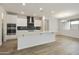 Bright kitchen with white cabinets, stainless steel appliances, and a large island perfect for entertaining at 19039 W Rose Ln, Waddell, AZ 85355