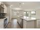 Open kitchen layout with stainless steel appliances, a center island, and wood flooring at 19039 W Rose Ln, Waddell, AZ 85355