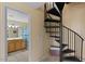 A spiral staircase leads up from the downstairs hallway to the upstairs rooms at 20100 N 78Th Pl # 2203, Scottsdale, AZ 85255