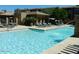A community pool with a sun shelf, fountain, and lounge chairs for relaxing by the water at 20100 N 78Th Pl # 2203, Scottsdale, AZ 85255