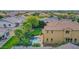 Aerial view of backyard with lush lawn, freeform swimming pool, patio with dining table, and desert landscaping at 21525 E Camacho Rd, Queen Creek, AZ 85142