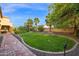 Expansive backyard featuring lush green lawn, mature trees, and manicured landscaping at 21525 E Camacho Rd, Queen Creek, AZ 85142
