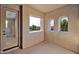 Covered outdoor balcony with views of the surrounding neighborhood through framed windows at 21525 E Camacho Rd, Queen Creek, AZ 85142