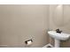 A clean powder room features a pedestal sink and decorative fixtures at 21525 E Camacho Rd, Queen Creek, AZ 85142