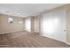 Bright bedroom with tan walls, neutral carpet, closet, and natural light at 21525 E Camacho Rd, Queen Creek, AZ 85142
