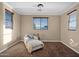 Bedroom with window and comfortable chair and ottoman plus neutral color scheme at 21525 E Camacho Rd, Queen Creek, AZ 85142