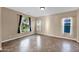 Well-lit bedroom with neutral walls, tile flooring, and multiple windows offering ample natural light and space at 21525 E Camacho Rd, Queen Creek, AZ 85142