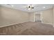 Open bonus room with neutral walls, carpet flooring, ceiling fan, and access to the second story at 21525 E Camacho Rd, Queen Creek, AZ 85142
