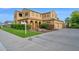 Well-maintained home with a manicured lawn, mature landscaping, and a welcoming driveway leading to a spacious garage at 21525 E Camacho Rd, Queen Creek, AZ 85142
