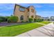 Charming two-story home with desert landscaping and a well-maintained lawn and inviting entryway at 21525 E Camacho Rd, Queen Creek, AZ 85142