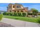 Charming single-Gathering home with a covered front porch, desert landscaping, and well manicured lawn at 21525 E Camacho Rd, Queen Creek, AZ 85142