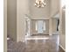 Grand foyer with high ceilings, a stylish chandelier, and tile flooring creating an open and inviting entryway at 21525 E Camacho Rd, Queen Creek, AZ 85142