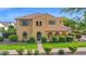 Inviting two-story home with green lawn, mature shrubs, arched entry and desert landscaping at 21525 E Camacho Rd, Queen Creek, AZ 85142