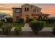 Charming two-story home featuring well-maintained landscaping and covered entry at 21525 E Camacho Rd, Queen Creek, AZ 85142