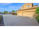 Spacious three car garage with long driveway and manicured landscaping at 21525 E Camacho Rd, Queen Creek, AZ 85142