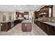 Spacious kitchen with an island, stainless appliances, granite counters and stylish tile floors at 21525 E Camacho Rd, Queen Creek, AZ 85142