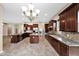 Huge kitchen features a central island, stainless appliances, beautiful counters, and great storage at 21525 E Camacho Rd, Queen Creek, AZ 85142