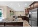 Modern kitchen with granite countertops, stainless steel appliances, and an open layout at 21525 E Camacho Rd, Queen Creek, AZ 85142