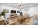 Inviting living room with comfortable seating, a rustic wooden coffee table, and a media center with a large screen TV at 21525 E Camacho Rd, Queen Creek, AZ 85142