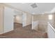 Upstairs loft area offers flexible space with neutral carpet and paint plus views to rooms beyond double doors at 21525 E Camacho Rd, Queen Creek, AZ 85142