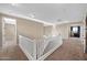 Open loft area with chandelier and neutral carpet and paint provides bright and airy gathering space at 21525 E Camacho Rd, Queen Creek, AZ 85142
