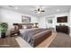 Well-lit primary bedroom featuring a refined aesthetic, neutral colors, and a large window at 21525 E Camacho Rd, Queen Creek, AZ 85142