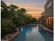 Backyard pool with palm trees and sunset views at 21525 E Camacho Rd, Queen Creek, AZ 85142