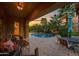 Back patio featuring a pool, waterfall, and patio furniture at 21525 E Camacho Rd, Queen Creek, AZ 85142