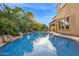 A stunning pool with rock features and lush landscaping, perfect for relaxing and entertaining at 21525 E Camacho Rd, Queen Creek, AZ 85142