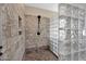 Modern shower with tiled walls, a rainfall showerhead, and a glass block partition at 21525 E Camacho Rd, Queen Creek, AZ 85142
