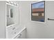 Bright bathroom featuring a modern vanity with a mirror and natural light from the window at 217 E Gwen St, Phoenix, AZ 85042