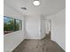 Bright bedroom with neutral carpet, a window with leafy tree view, and white trim at 217 E Gwen St, Phoenix, AZ 85042