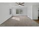 Bright bedroom with neutral carpet, a ceiling fan, and ample natural light from the windows at 217 E Gwen St, Phoenix, AZ 85042