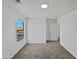 Bright bedroom featuring neutral carpeting, a window for natural light, and an open door to the bathroom at 217 E Gwen St, Phoenix, AZ 85042