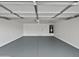 Spacious garage with finished floor, ample space, and an access door to the home at 217 E Gwen St, Phoenix, AZ 85042