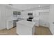 Well-lit kitchen features stainless steel appliances, granite countertops, island, and ample cabinet space at 217 E Gwen St, Phoenix, AZ 85042