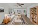 Bright living room with neutral tones, ceiling fan, and stylish striped rug at 217 E Gwen St, Phoenix, AZ 85042