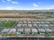 Aerial shot of community with uniform tile-roofed houses with desert landscaping and surrounding greenery at 22884 E Via De Olivos --, Queen Creek, AZ 85142